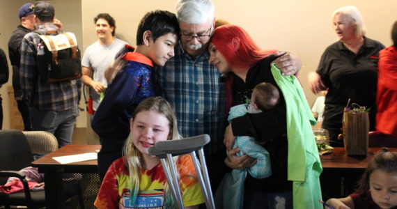 A family hugs after learning they were selected for home ownership through Habitat for Humanity. Relative and friends of the families selected attended the reveal to celebrate. (Photo by Karina Andrew/Whidbey News-Times)