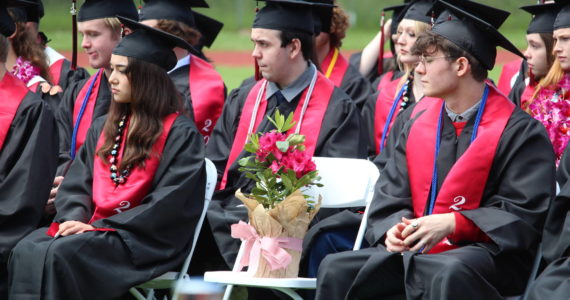 Photo by Karina Andrew/Whidbey News-Times
Graduating Coupeville seniors leave a seat for Bennett Boyles, their classmate who passed away in 2017 after a battle with brain cancer and would have graduated with them this year.