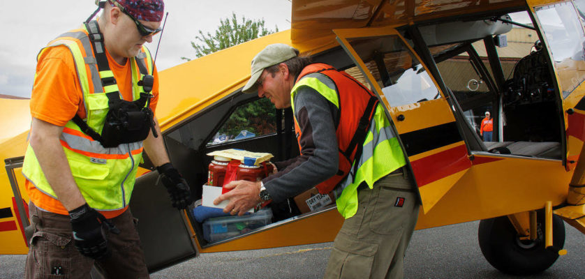 Photo By David Welton
Volunteers unload food donations from an airplane.