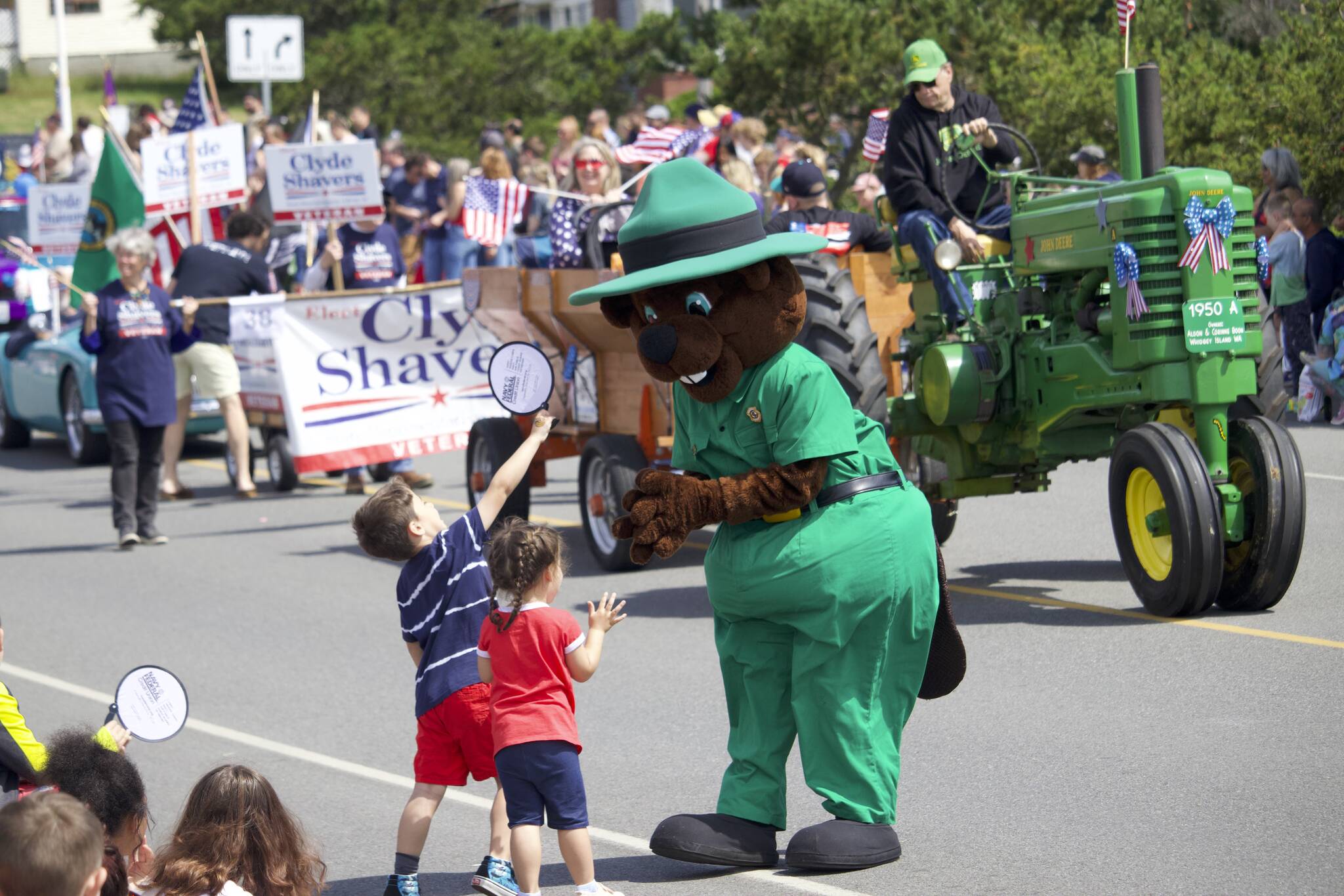A Deception Pass State Park “ranger” hands out candy to children in the Oak Harbor Fourth of July parade.