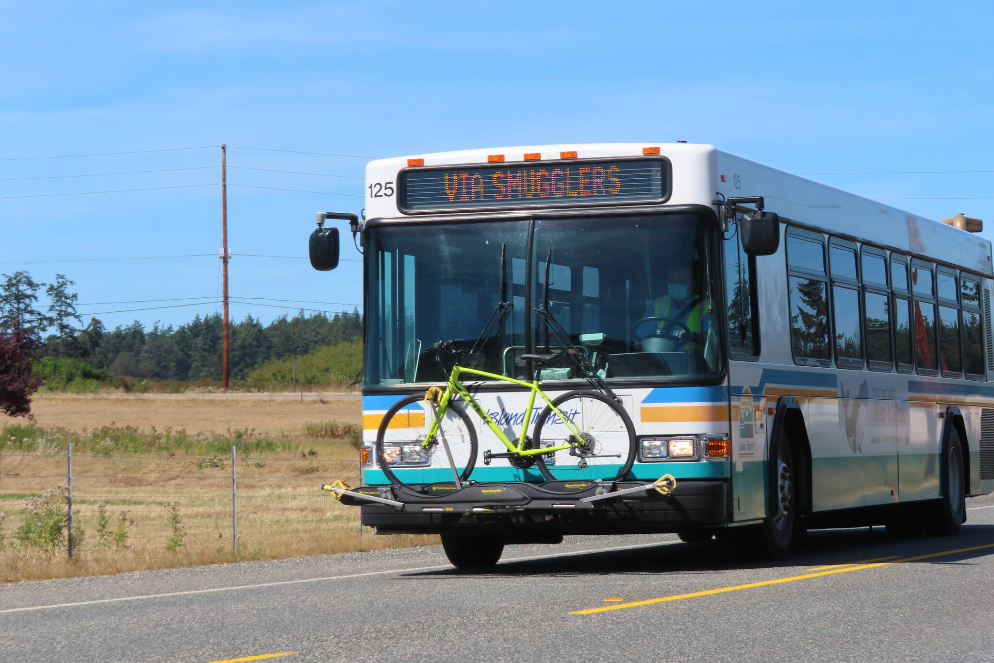 An Island Transit bus driving in a rural area. (Photo provided by Island County Transit).