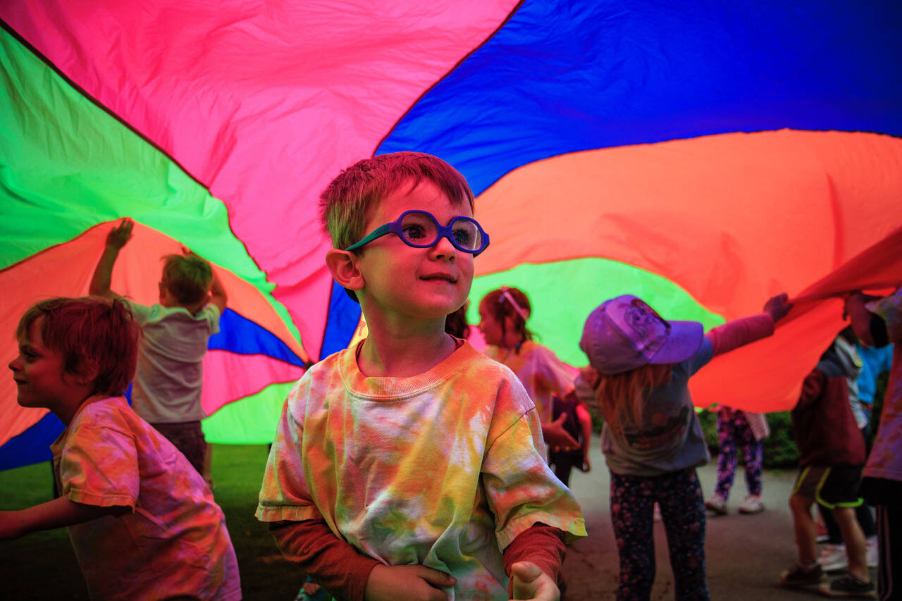 A child plays under a parachute during Family Story Time at Castle Park in Langley July 6. (Photo by David Welton)
A youngster plays under a parachute at Family Story Time at Castle Park in Langley July 6. (Photo by David Welton)