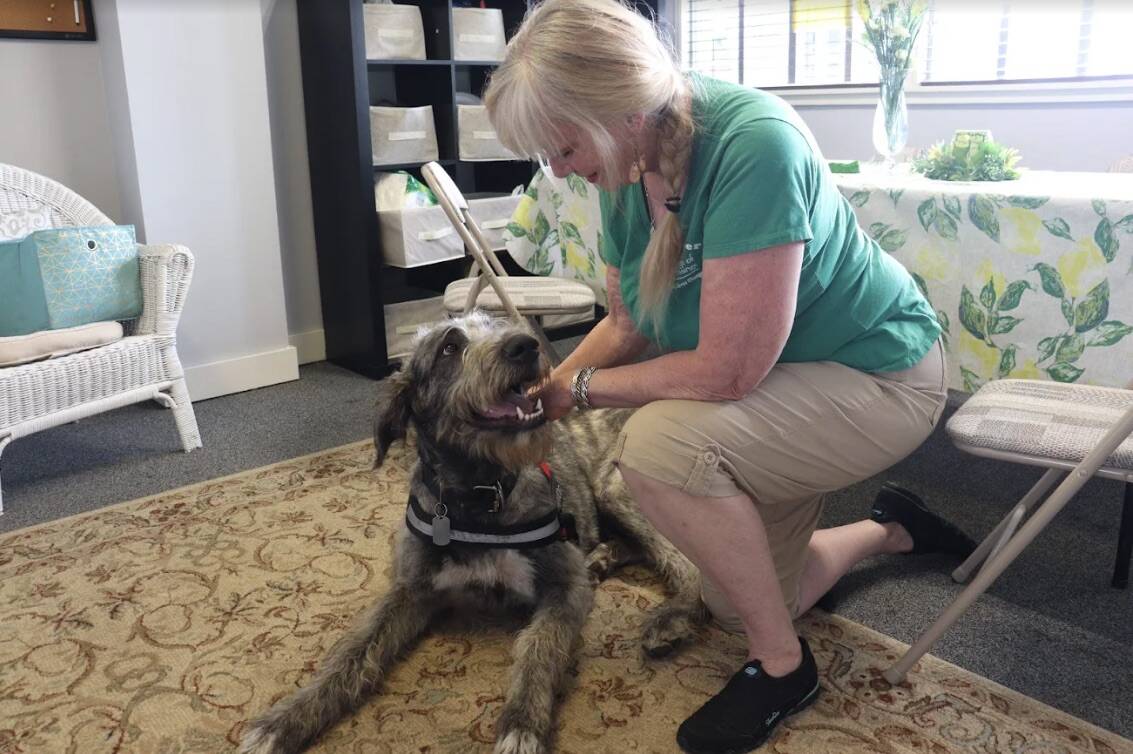 TJ Harmon Fisher sits with her service dog Brody. (Photo by Rachel Rosen/Whidbey News-Times)