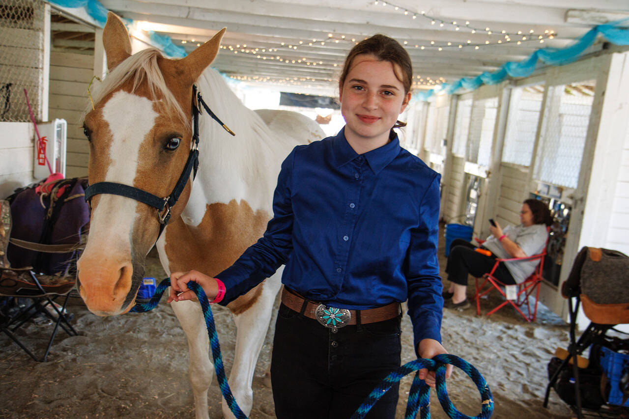 Promise Rose, 13, with Scout, a horse with unusual blue eyes. This is Rose’s first year showing horses through 4-H.