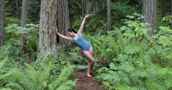 Julia Y. James of The Stone Dance Collectives dances in the woods. (Photo by Tuesday Sands)
