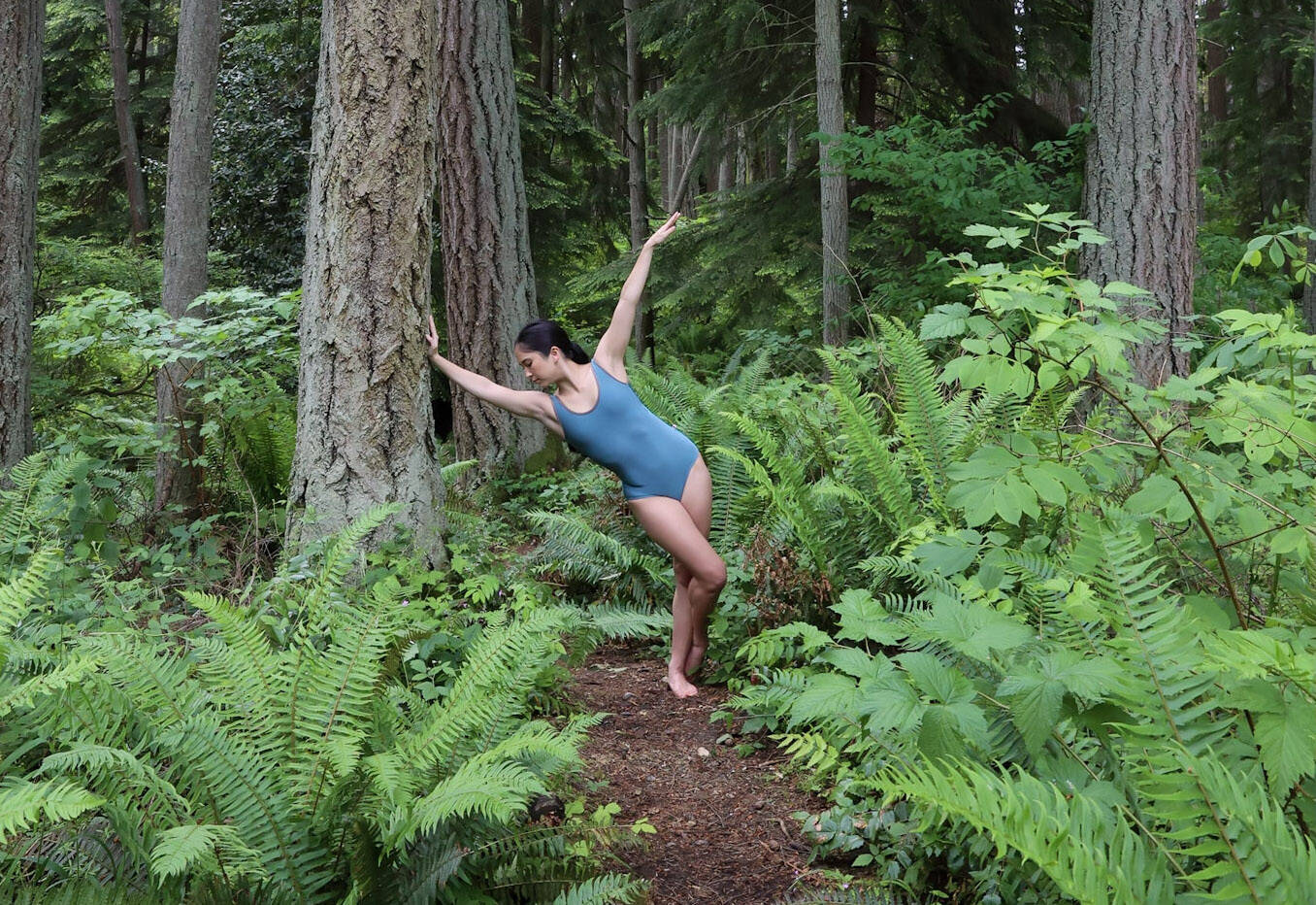 Julia Y. James of The Stone Dance Collectives dances in the woods. (Photo by Tuesday Sands)