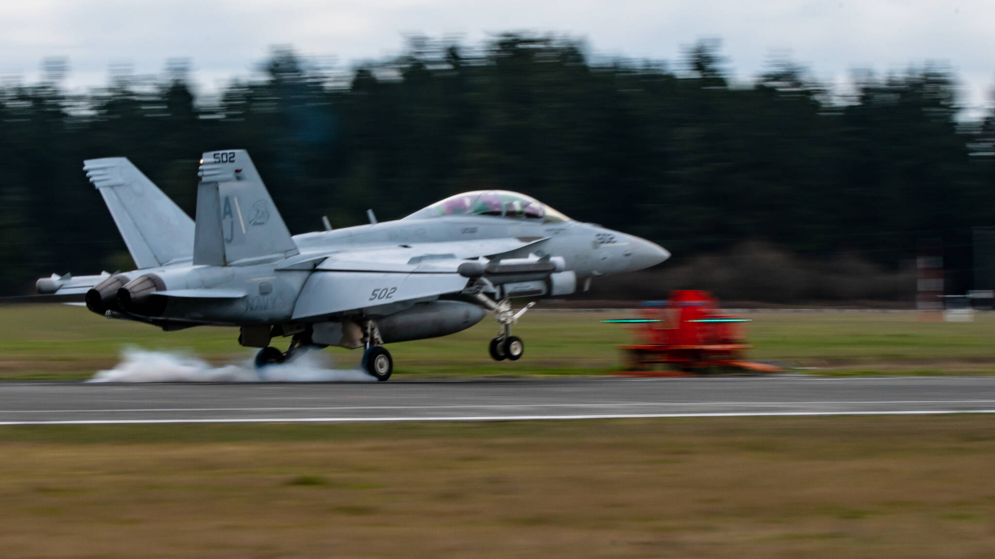 An EA18-G Growler practices at Outlying Field Coupeville. (AvgeekJoe Productions)
An EA18-G Growler touches down and burns some rubber during practice at Outlying Field Coupeville. (AvgeekJoe Productions)