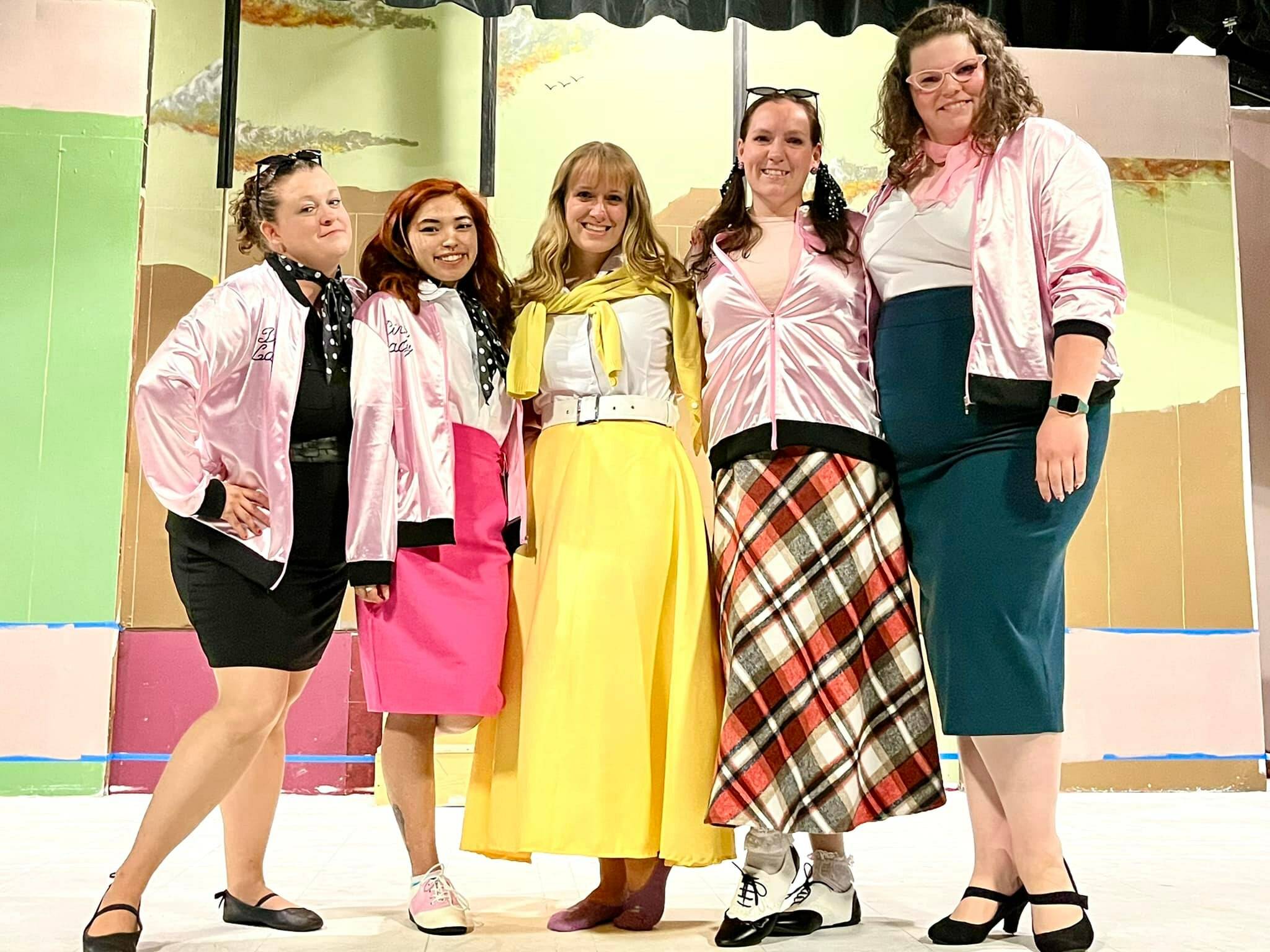 From left, “Grease” cast members Sara Hampton, Marianne Campos, Karina Andrew, Jordon Spanovich and Erin Tombaugh rehearse at the Whidbey Playhouse. (Photo provided)