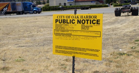 The city of Oak Harbor placed a notice on the corner of Tate Route 20 and Barrington Drive. (Photo by Rachel Rosen/Whidbey News-Times)
