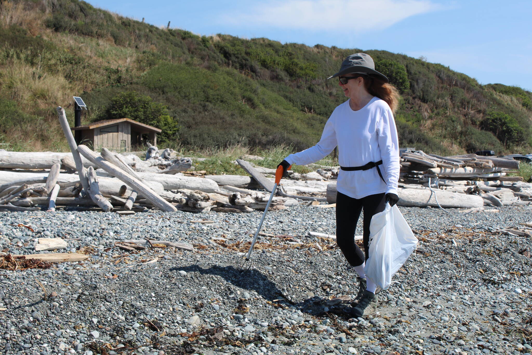 Volunteer Deb Savalza helps clean up a Central Whidbey beach on Aug. 30.