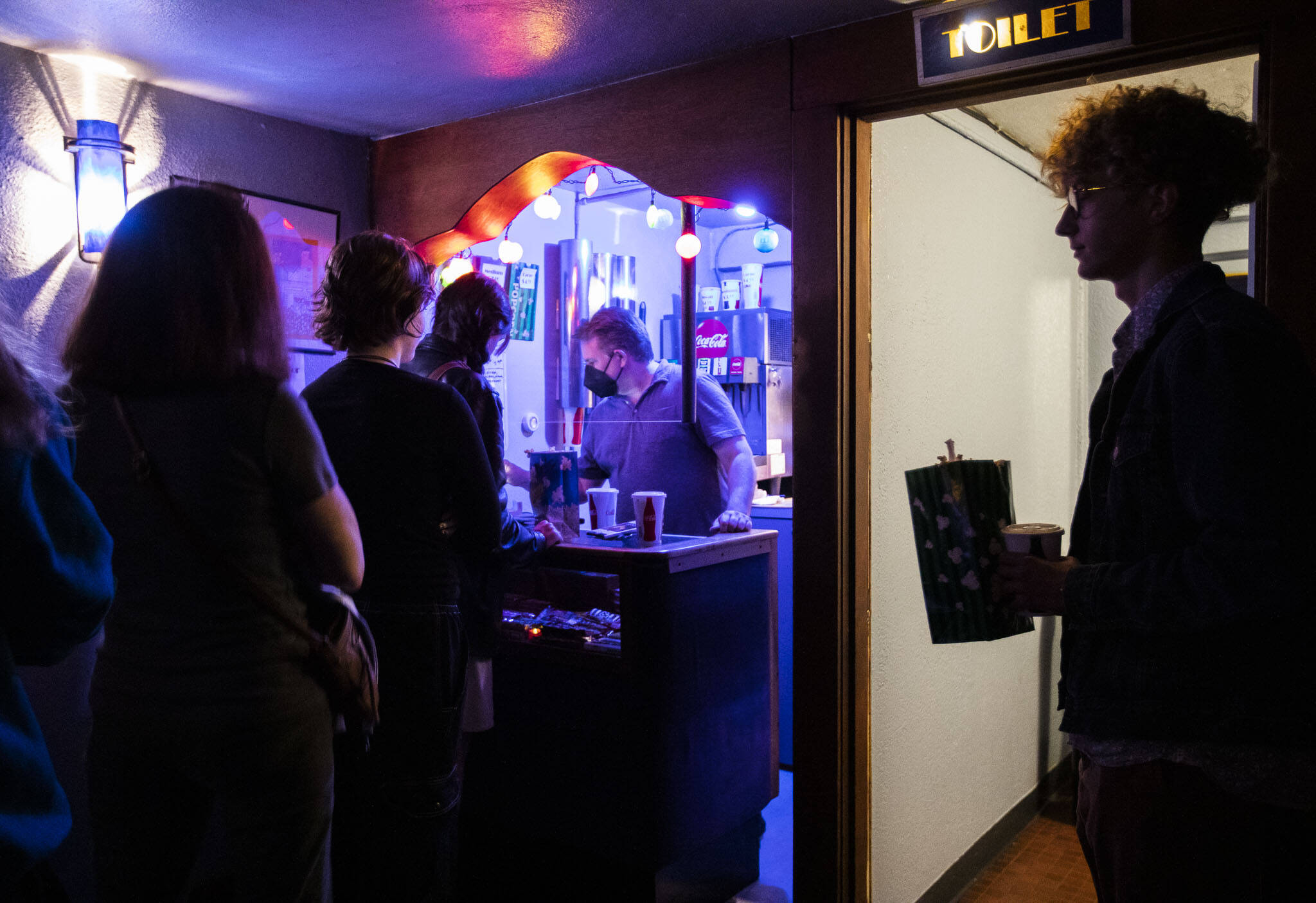 Patrons line up for order popcorn, soda, candy and other movie theater snacks. (Olivia Vanni / The Herald)