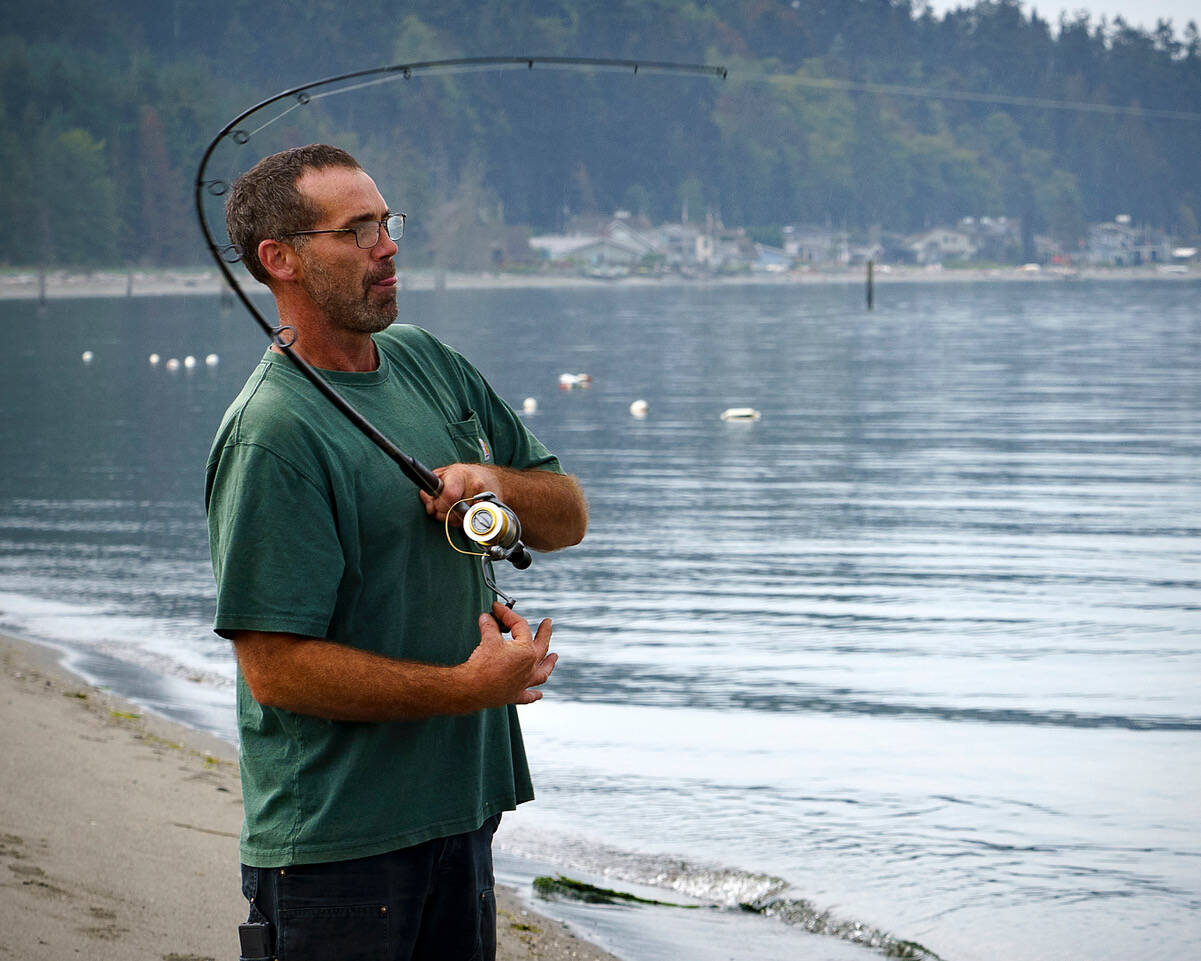 Photo by David Welton
Langley resident Gary Reeves reels in a fish at Robinson Beach in Freeland, near where the closed Mutiny Bay boat ramp is located.