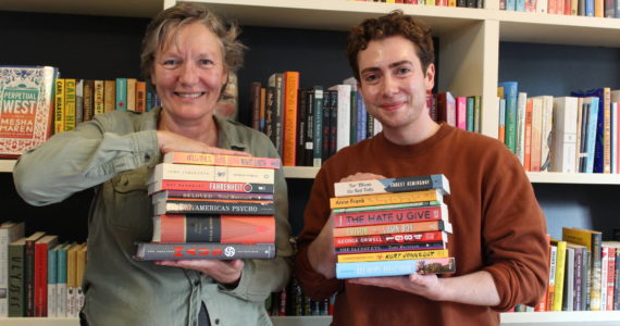 Photo by Karina Andrew/Whidbey News-Times
Meg Olson and Felix Hall show off some of the classic and contemporary titles found at Kingfisher Bookstore that have faced challenges or ban attempts at various points throughout history.