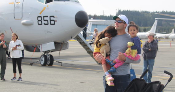 Photo by Karina Andrew/Whidbey News-Times
A family watches a Navy Search and Rescue demonstration during an open house at Naval Air Station Whidbey Island Sept. 17. T