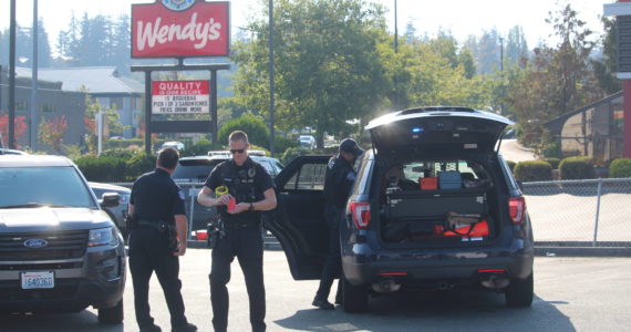 Photo by Karina Andrew/Whidbey News-Times
Oak Harbor police officers secure the scene of an arrest of a man who made a bomb threat Monday afternoon.