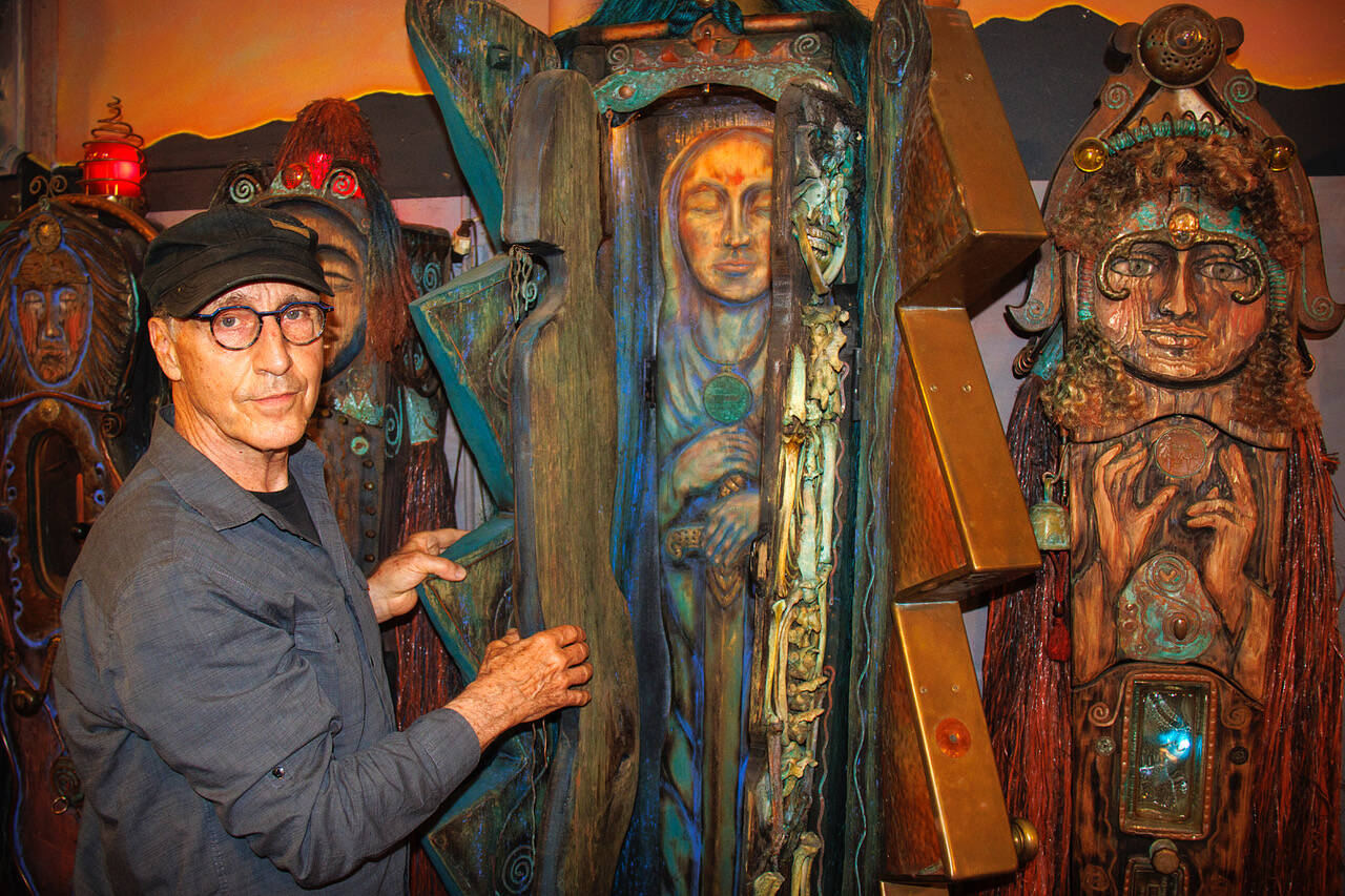 Jerry Wennstrom with “Lightning,” a multi-layered sculpture. Wennstrom’s second body of artistic work consists of several tall, wooden sculptures resembling women that are meant to represent complex themes of birth and death, good and evil, femininity and masculinity.