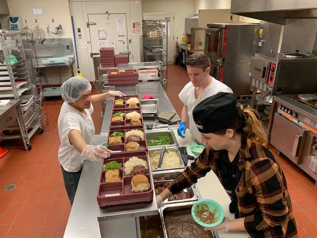 Photo courtesy of jail At right, Clare Brown, supervising cook in the Island County Jail, prepares meals for inmates Monday night. The county contracts with food vendor Summit for the facility.