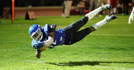Photo by John Fisken
South Whidbey senior Cole Tschetter dives to the ground with the ball during a game against King’s on Oct. 14.