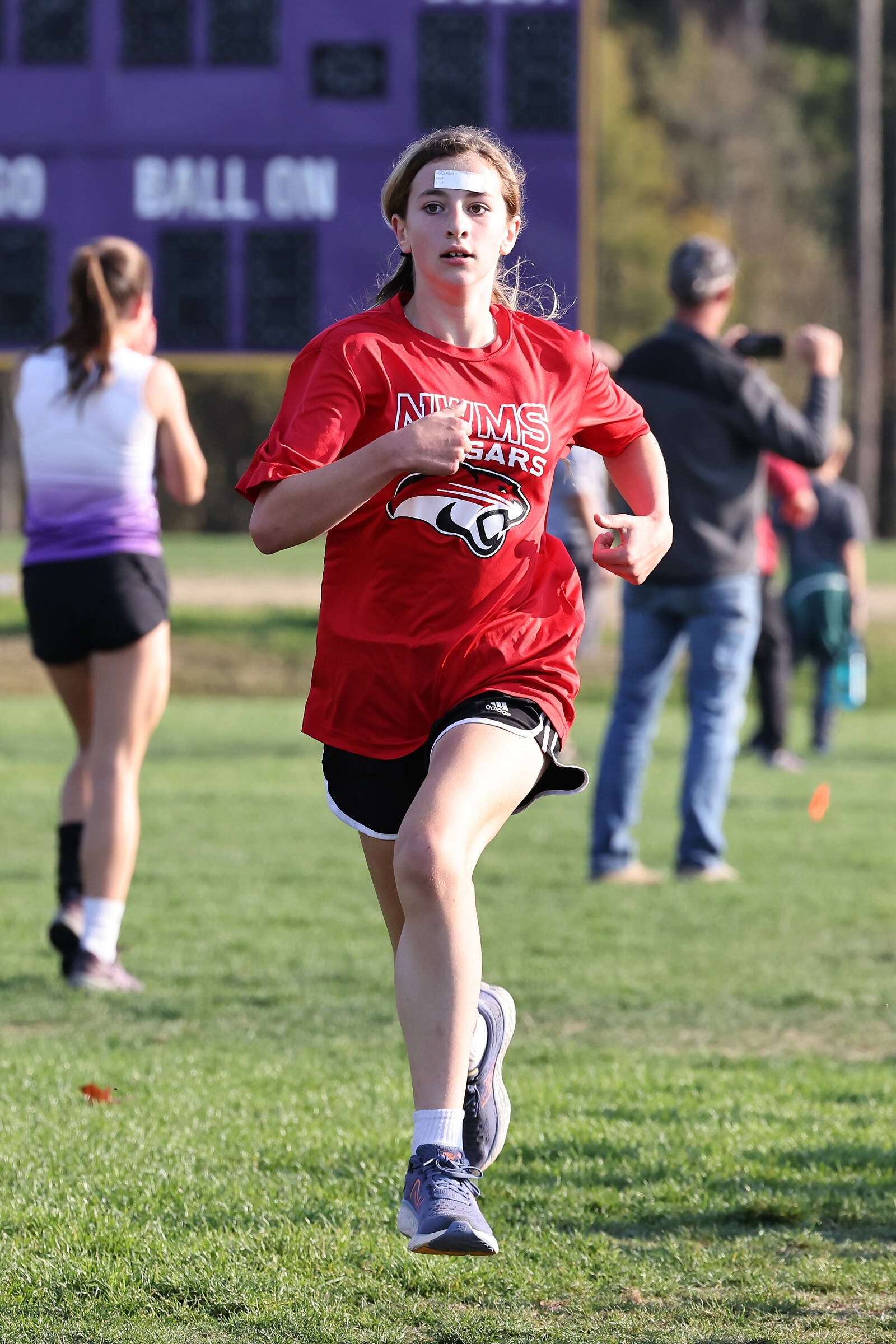 Photo by John Fisken
North Whidbey Middle School seventh grader Kassidy Neal races in the cross country league championships at Ft. Nugent Park Oct. 18. Neal finished third place in this race, and all her other races this season.