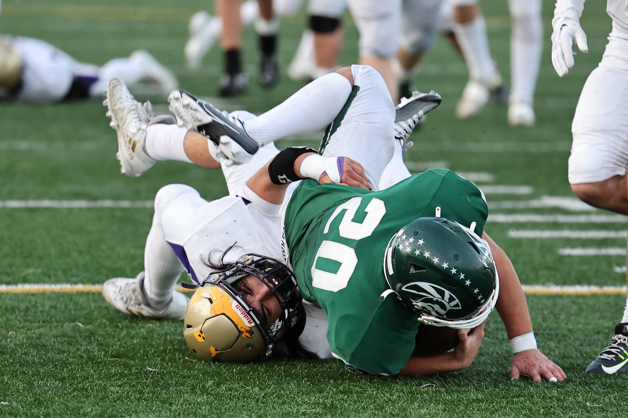 Aiden Finley tackles an opponent during the playoff game at Edmonds Oct. 28. (Photo by John Fisken)