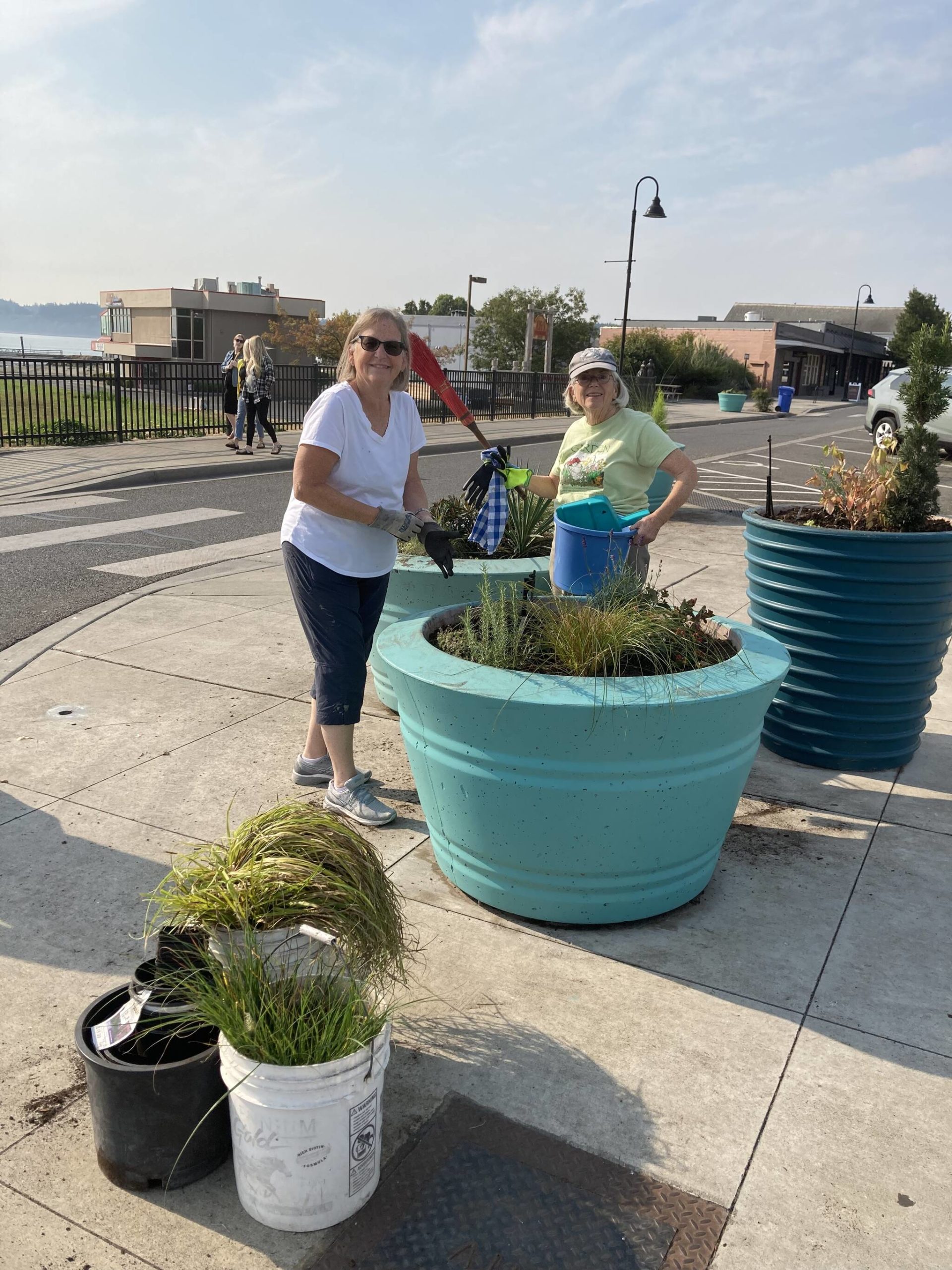 Photo provided
Oak Harbor Garden Club members Monica Cays and Kathy Harbour plant daffodil bulbs in the blue pots along Pioneer Way.