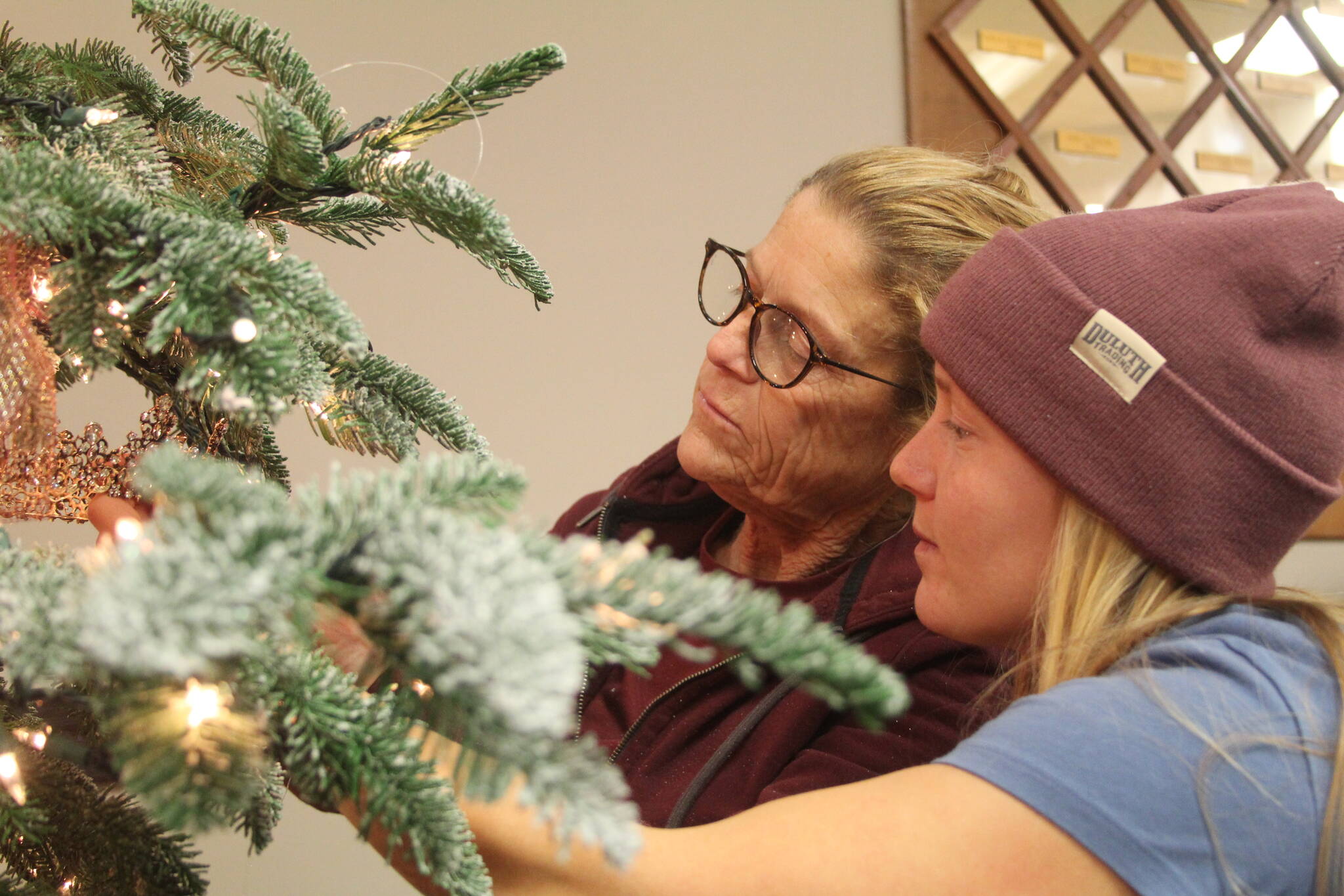 From left, Karlyne Larsen and her daughter Nichelle Krieg decorate a tree for the gala.