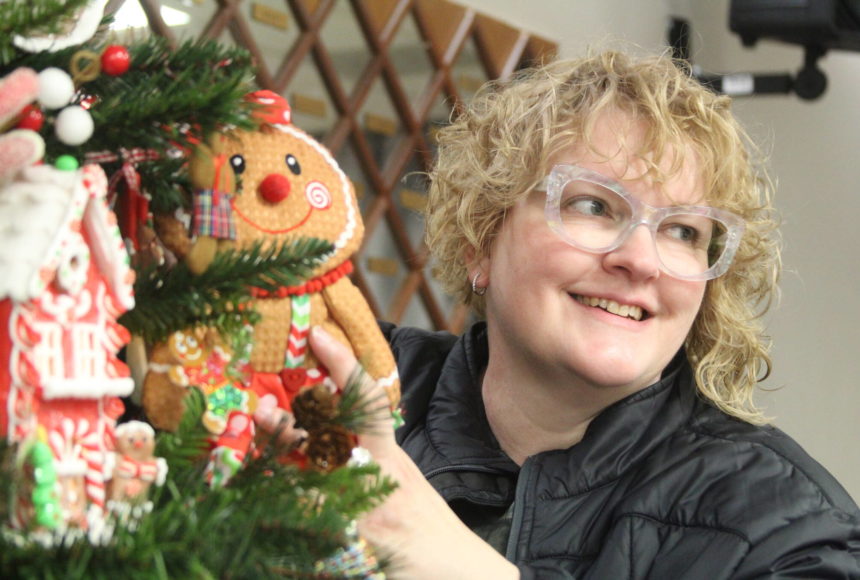 <p>Photo by Karina Andrew/Whidbey News-Times</p>
                                <p>Decorating coordinator Hope McCormack puts a finishing touch on a gingerbread-themed tree.</p>