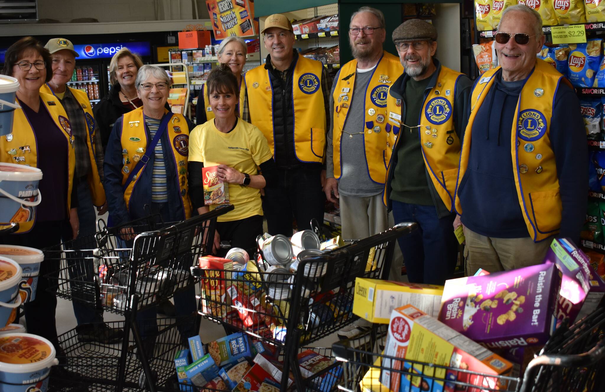 Photo provided
From left, Coupeville mayor Molly Hughes, Gary Youngs, Becky Johnson, Sue Hartin, Sandy Johnson, Jennifer Carroll, Mike Carroll, Dennis Egan, Gary Parker and Hugh Hedges stand with carts of groceries that the Gifts from the Heart Food Bank won in an annual shopping spree raffle.