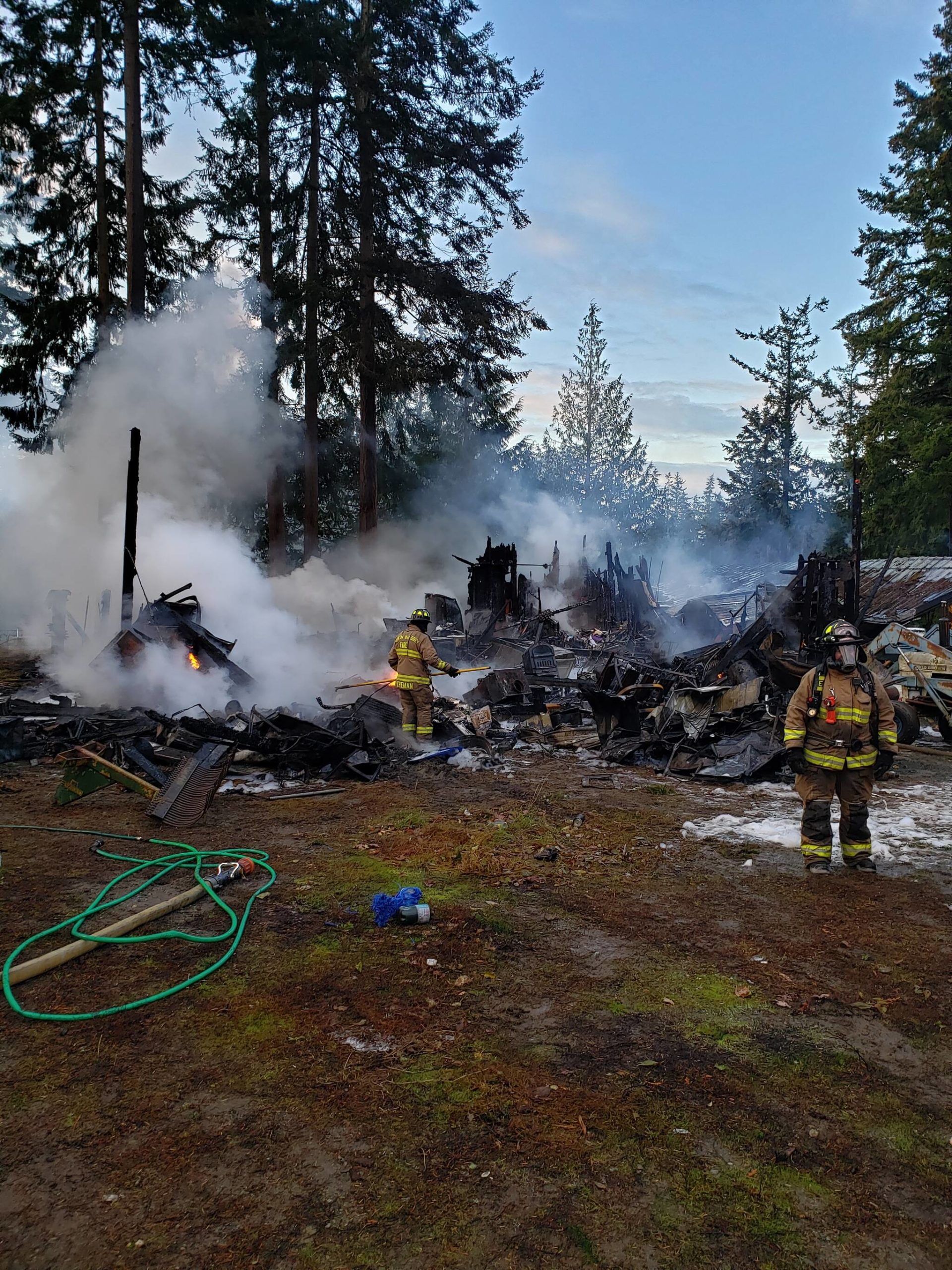 Photo provided
North Whidbey Fire and Rescue firefighters subdue a structure fire on Cerullo Drive the morning of Dec. 3.