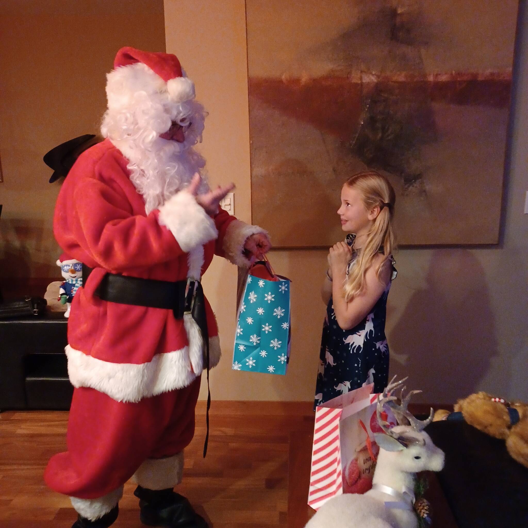 Photo provided
Mark Stewart Cassidy as Santa Claus delivers a gift to a young girl during a recent house call.