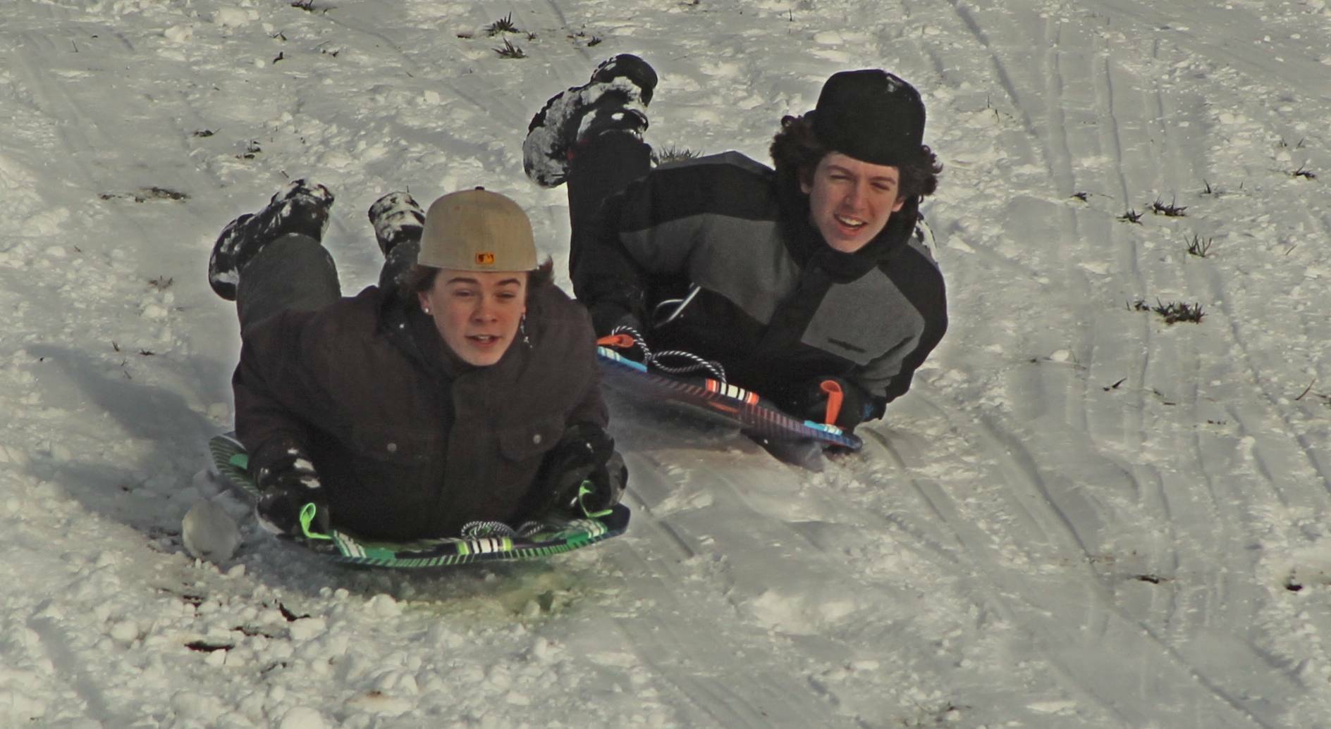 Photo by Karina Andrew/Whidbey News-Times
Oak Harbor High School sophomores Jayson Champignon, left, and Brayden Rupp race downhill on sleds.