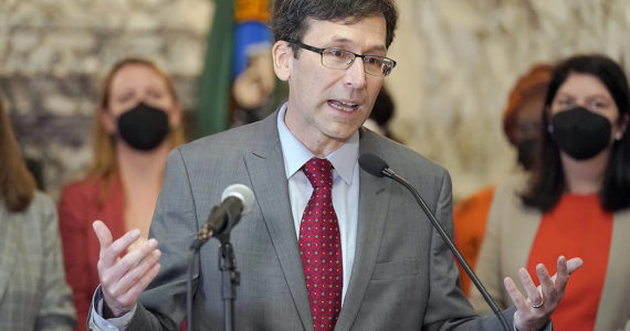 FILE - Washington Attorney General Bob Ferguson speaks March 23, 2022, at the Capitol in Olympia, Wash. Months into a complex trial over their role in flooding Washington with highly addictive painkillers, the nation's three largest opioid distributors have agreed to pay the state $518 million. Ferguson announced the deal Tuesday, May 3, 2022. (AP Photo/Ted S. Warren, File)