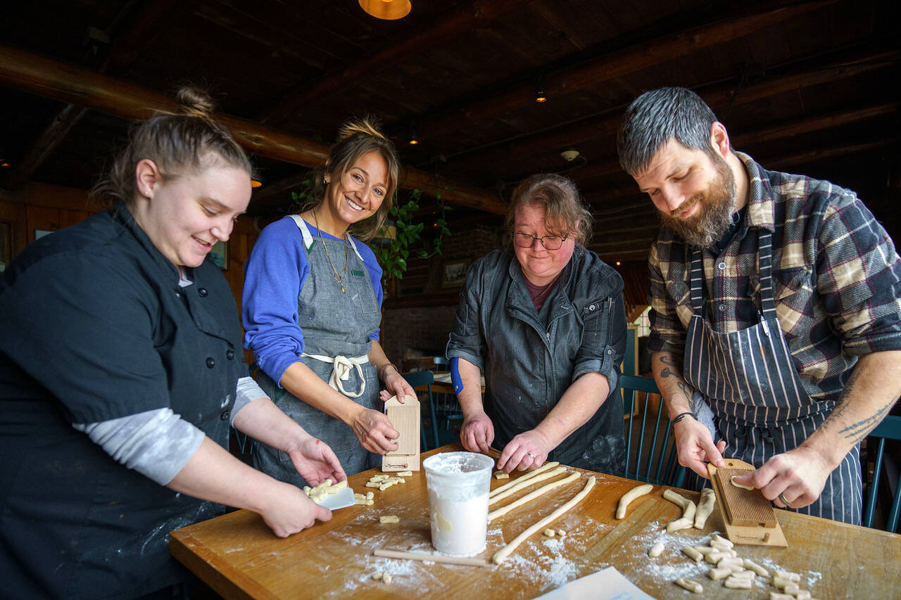From left, Amy Wise, Courtney Storer, Alison Wiefels and Captain Whidbey head chef Sean Prater make homemade pasta. (Photo by David Welton)