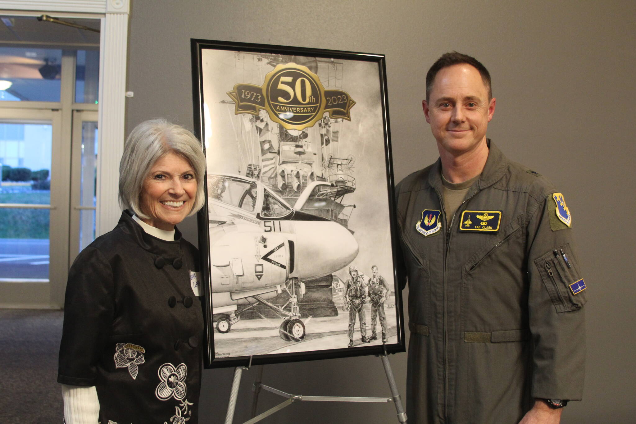Photo by Karina Andrew/Whidbey News-Times
Tonya Clark and her son, Brigadier General Tad Clark, receive a painting of their husband and father, bombardier Robert Clark, with his pilot, Michael McCormick, who were shot down over North Vietnam in 1973.