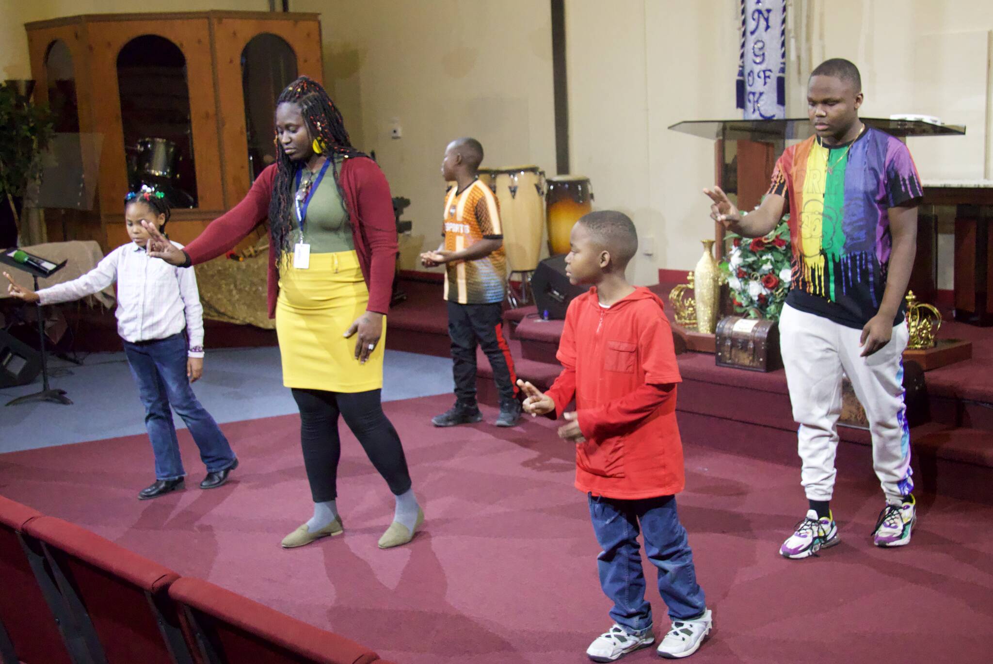 Wismine D’Avilar (second from left) leads a rehearsal for the annual Martin Luther King Jr. event at the House of Prayer. (Photo by Rachel Rosen/Whidbey News-Times)
