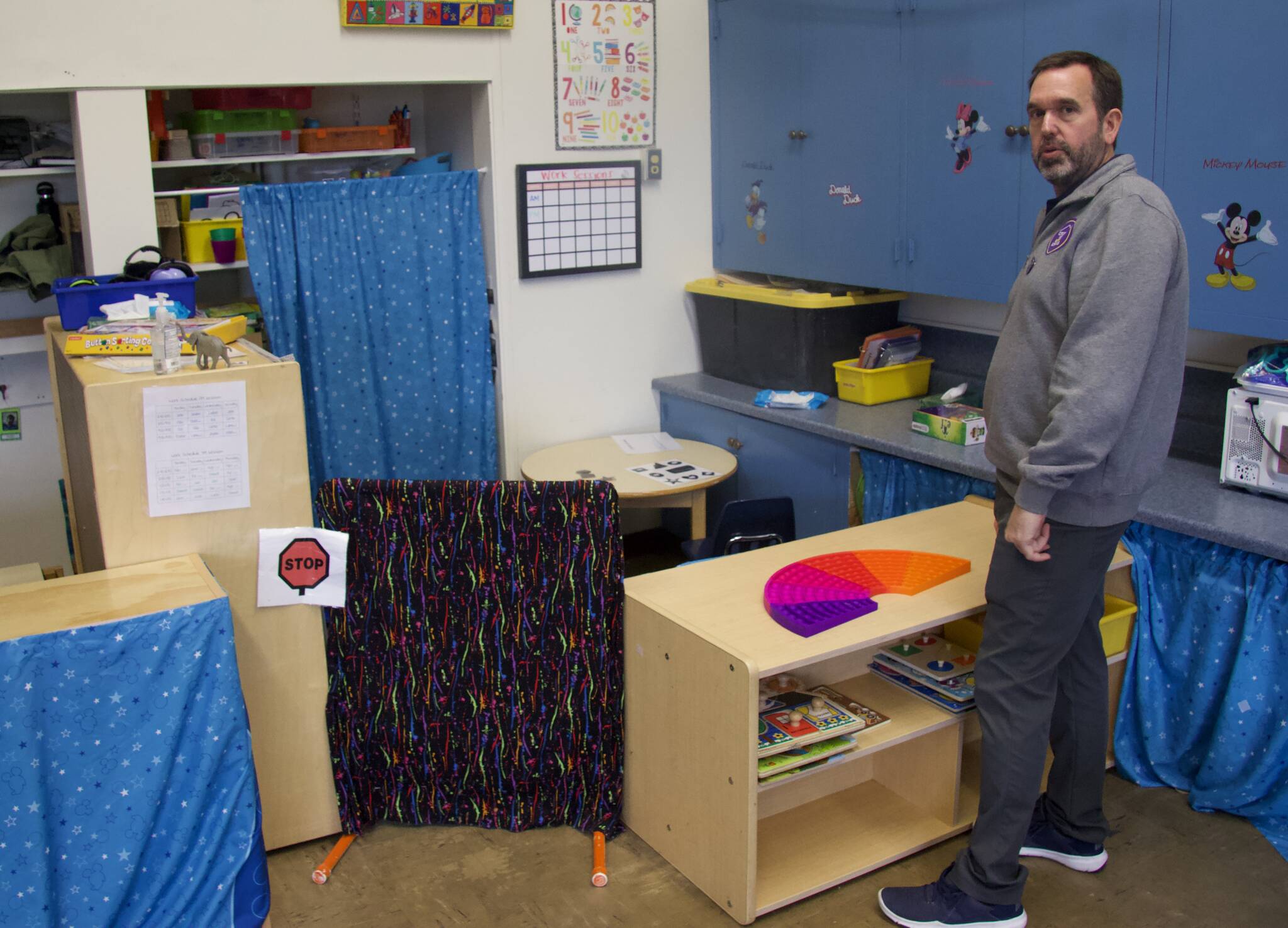 Hand-in-Hand and HomeConnection Principal Shane Evans stands in front of a makeshift partition a teacher made in order to have space for individual student work. (Photo by Rachel Rosen/Whidbey News-Times)