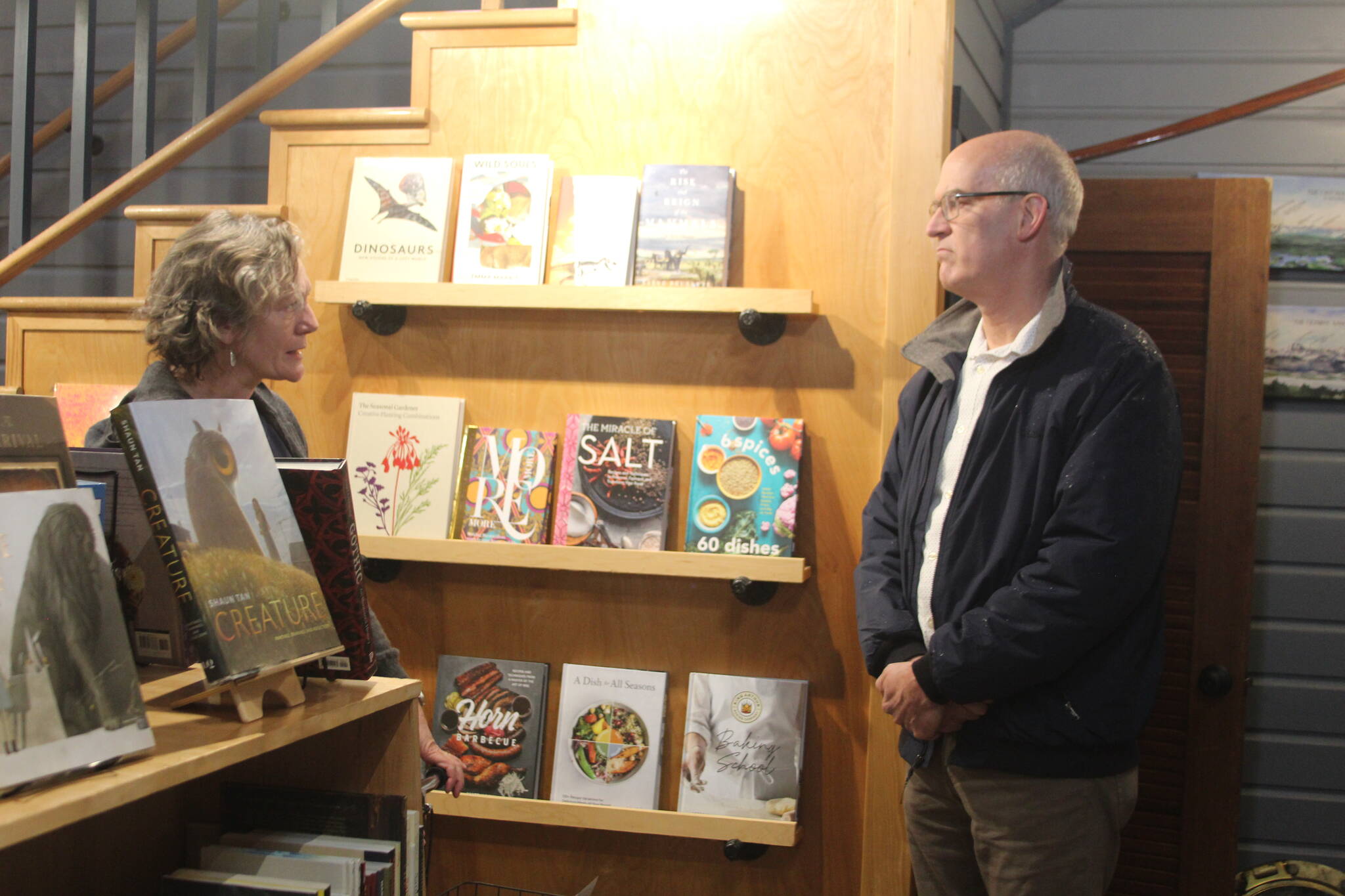 Meg Olson, left, tells Rep. Rick Larsen about the troubles her shop, Kingfisher Bookstore, encountered during the last king tide. (Photo by Karina Andrew/Whidbey News-Times)