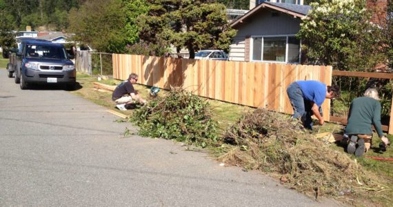 Photo provided
Central Whidbey Hearts and Hammers volunteers do yard work during last year’s work day.