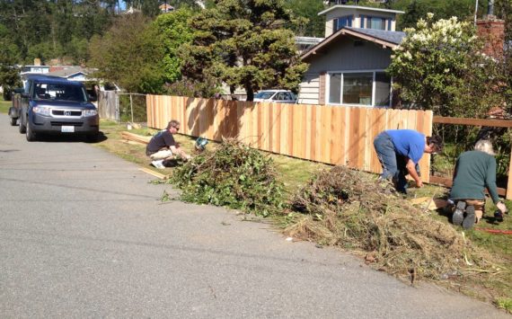 Photo provided
Central Whidbey Hearts and Hammers volunteers do yard work during last year’s work day.