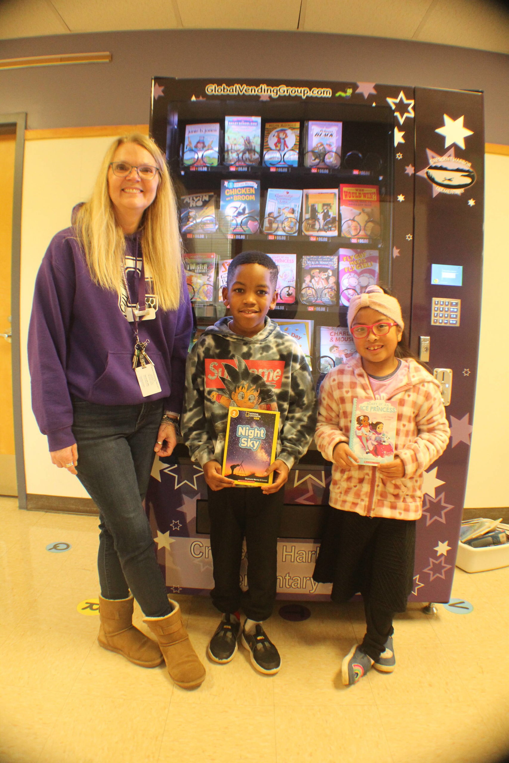 Photo by Karina Andrew/Whidbey News-Times
From left, Glenda Jackson, Trenton Miller and Cristal Hernandez Cruz enjoy the book vending machine, new to Crescent Harbor Elementary School this school year.