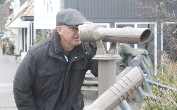 Photo by Kira Erickson/South Whidbey Record
Callahan McVay peers through a telescope on First Street in Langley. During the pandemic, the Langley Main Street Association installed the telescopes, which make for great whale-watching opportunities.