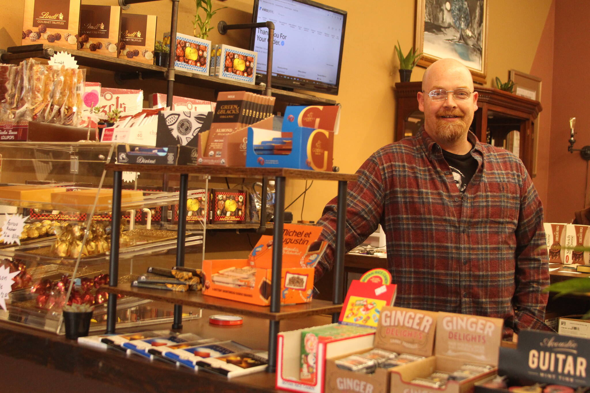 Photos by Karina Andrew/Whidbey News-Times
Above, Ryan Prichard mans the counter at Whidbey Wonka’s Chocolate Co., his new business on Pioneer Way. 	Below, Prichard plays the guitar in the shop.