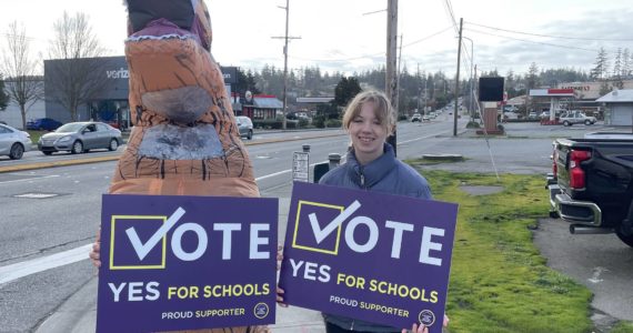 A student and a dinosaur were among those who campaigned for the school bond measure.