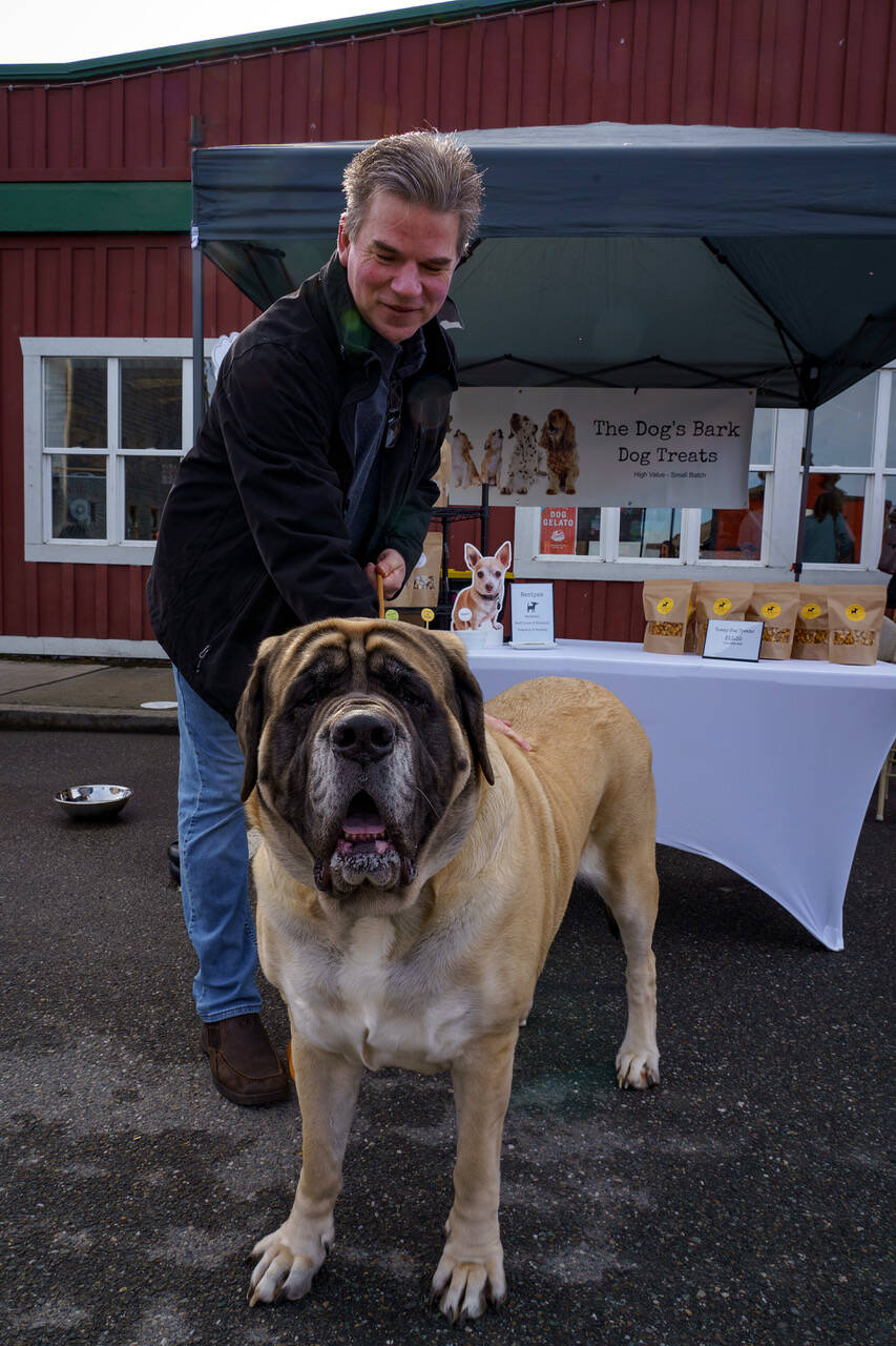 Ron Newberry and his pooch visit a dog treat vendor.