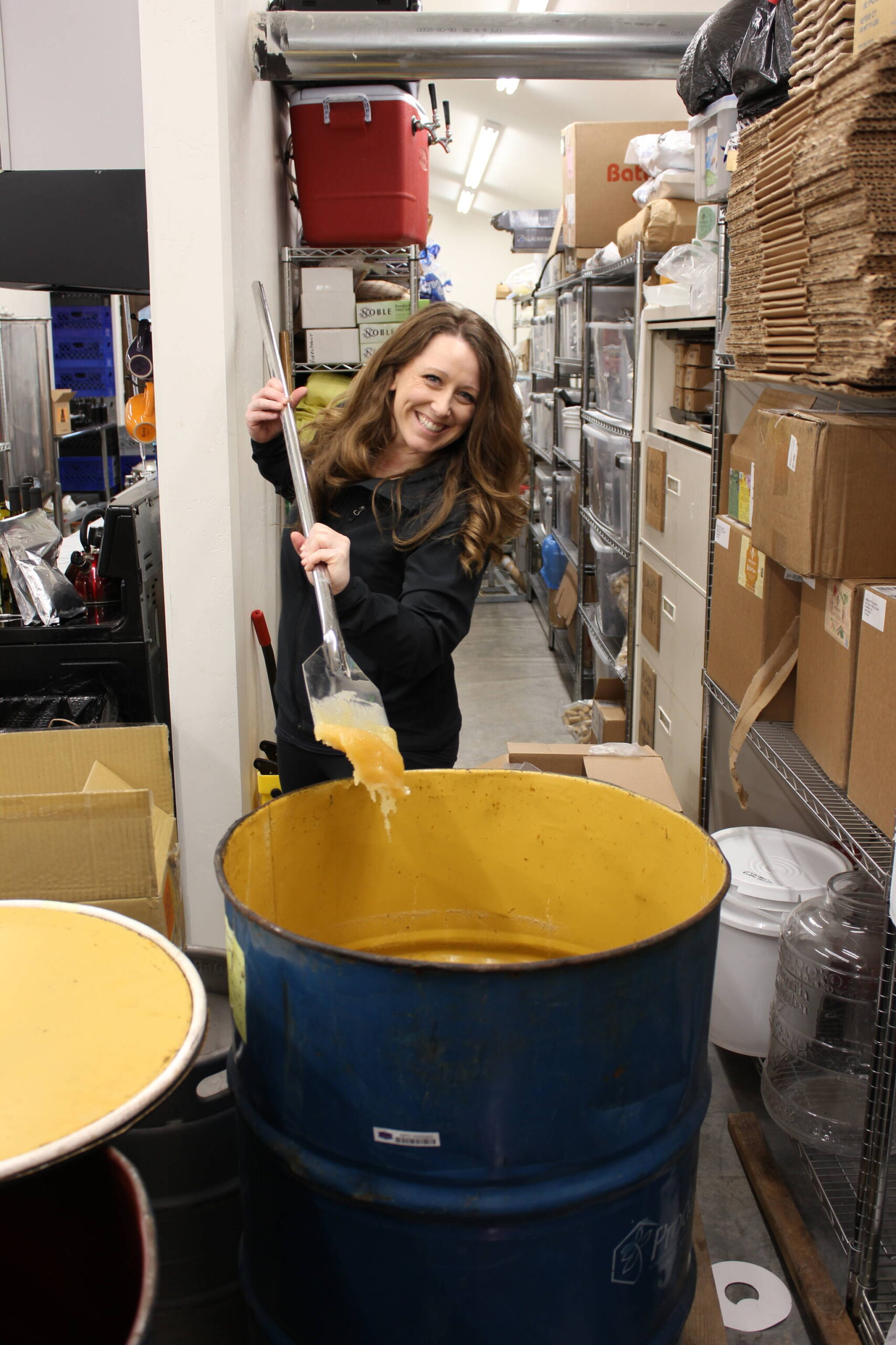 Photo provided
Michelle Scandalis scoops some honey during the mead-making process.
