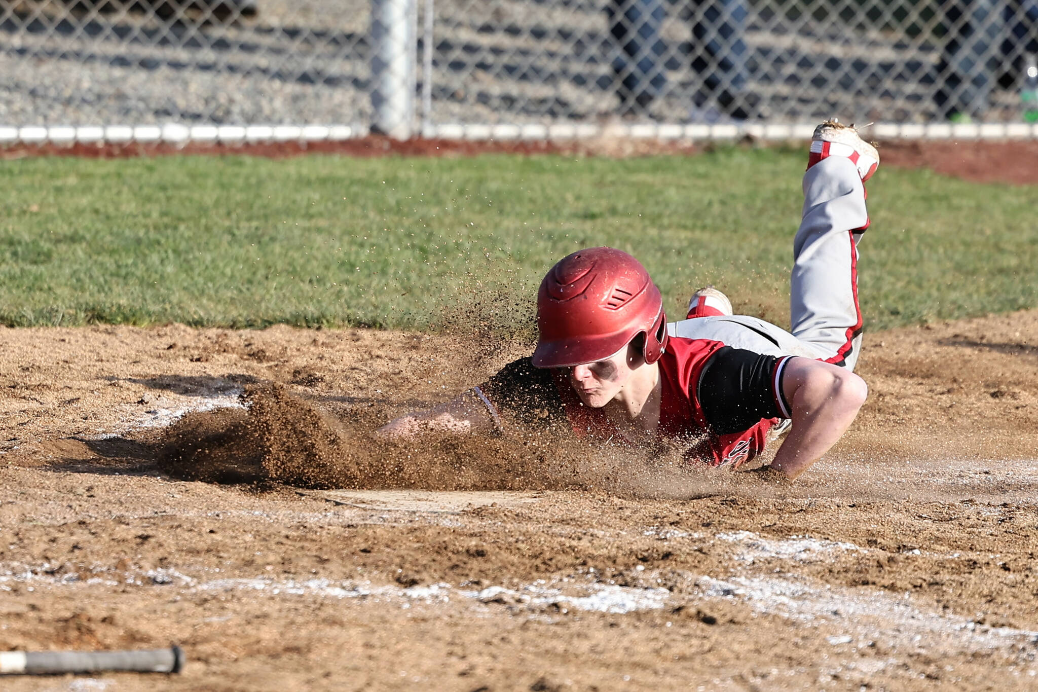 Coupeville High School freshman Aiden O’Neill, slides into a base during a game against South Whidbey High School March 15. Coupeville beat South Whidbey 13-2 in the baseball season opener.