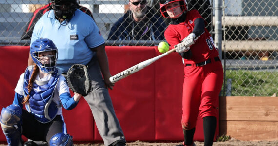 Photos by John Fisken
Coupeville High School sophomore Taylor Brotemarkle, the team’s starting shortstop, takes a swing in a softball game against South Whidbey High School March 15, while South Whidbey sophomore Josalynn Jaeger-Funcannon catches.
