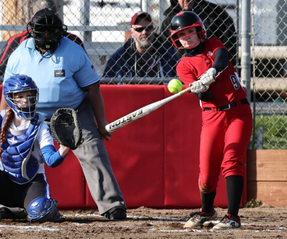 Photos by John Fisken
Coupeville High School sophomore Taylor Brotemarkle, the team’s starting shortstop, takes a swing in a softball game against South Whidbey High School March 15, while South Whidbey sophomore Josalynn Jaeger-Funcannon catches.