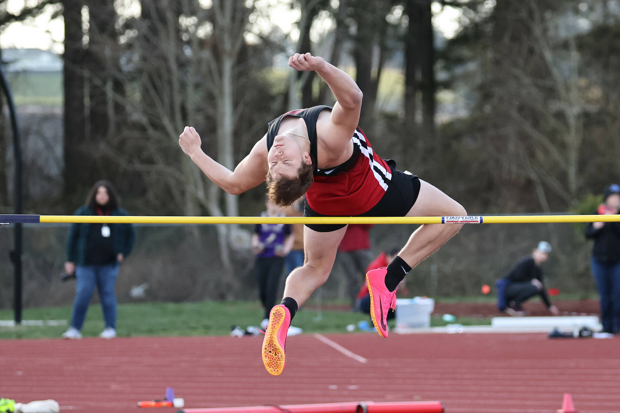 Senior Dominic Coffman competes in the high jump March 22 during Coupeville High School’s first home track and field meet of the season. Coffman took second place in the event with a jump of 5-08. (Photo by John Fisken)