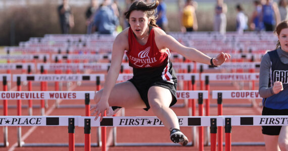 Photo by John Fisken
Freshman Liza Zustiak runs in a hurdle event March 22 during Coupeville High School's first home track and field meet of the season. Zustiak competed in the 100 meter hurdles and 300 meter hurdles, winning 9th place in both events and earning a personal record of 23.56 seconds in the 100 meter hurdles race.